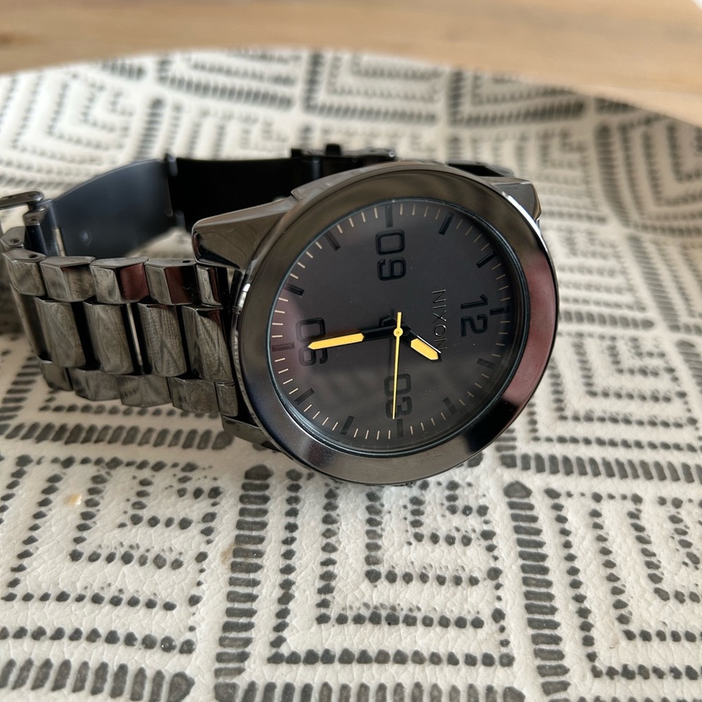 Nixon corporal stainless watch in gunmetal with orange accents.